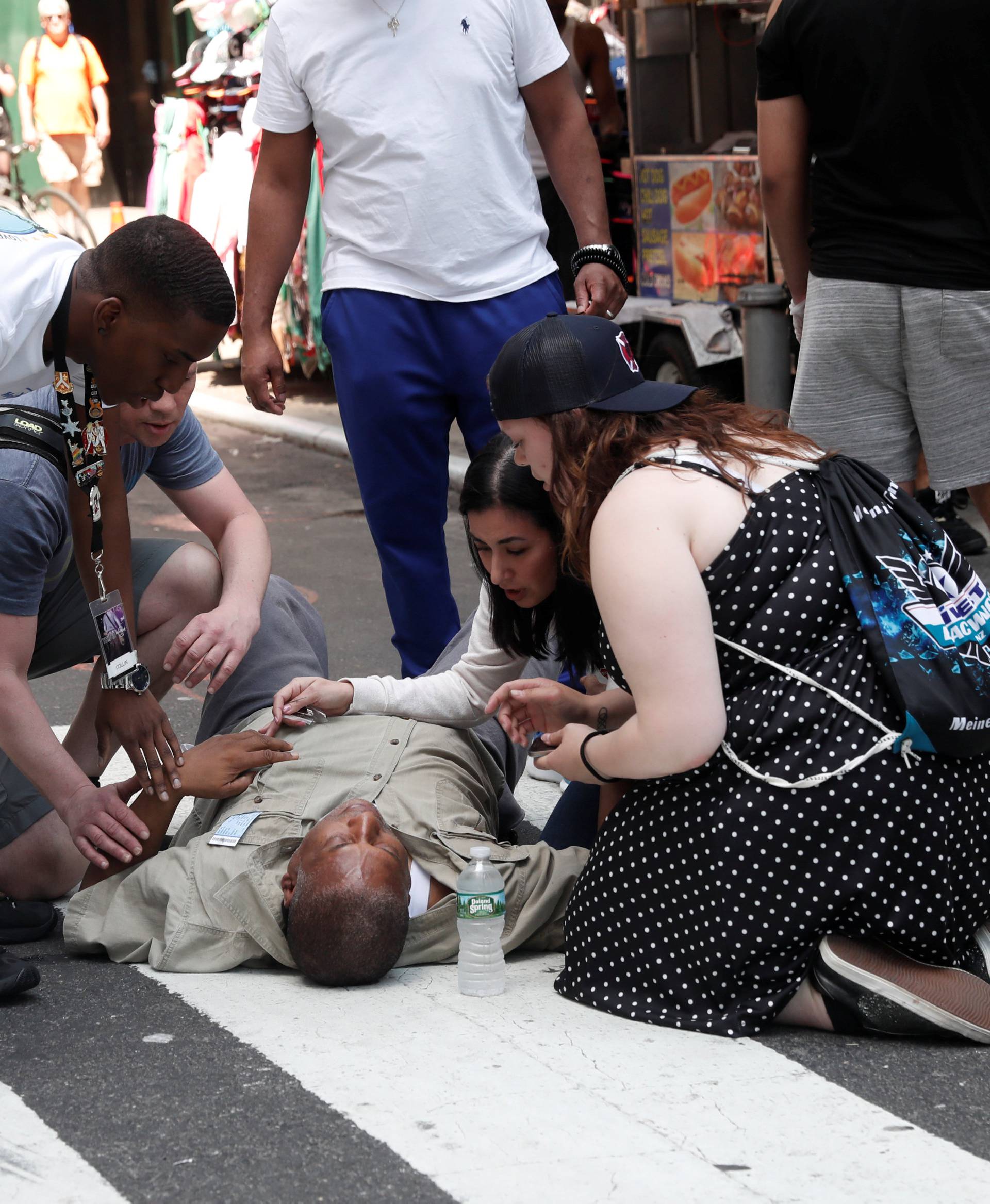 An injured man is seen on the sidewalk in Times Square after a speeding vehicle struck pedestrians on the sidewalk in New York City