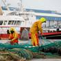 FILE PHOTO: French fishermen repair their nets at Boulogne-sur-Mer, northern France