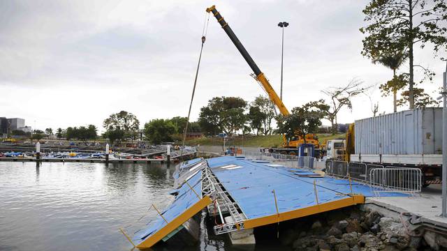 A ramp built for competitors' boats to reach the water hangs after collapsing at the Marina da Gloria in Rio de Janeiro