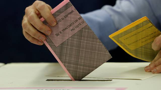 A man casts his vote at a polling station in Milan