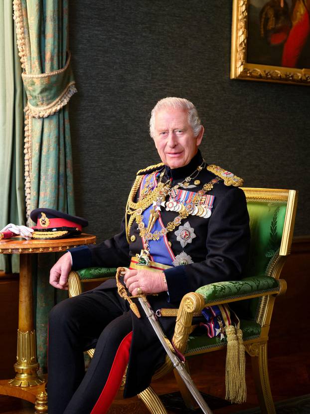 Britain's King Charles poses for a picture while wearing his Field Marshal No1 Full Ceremonial Frock Coat with medals, sword and decorations, in this undated handout picture