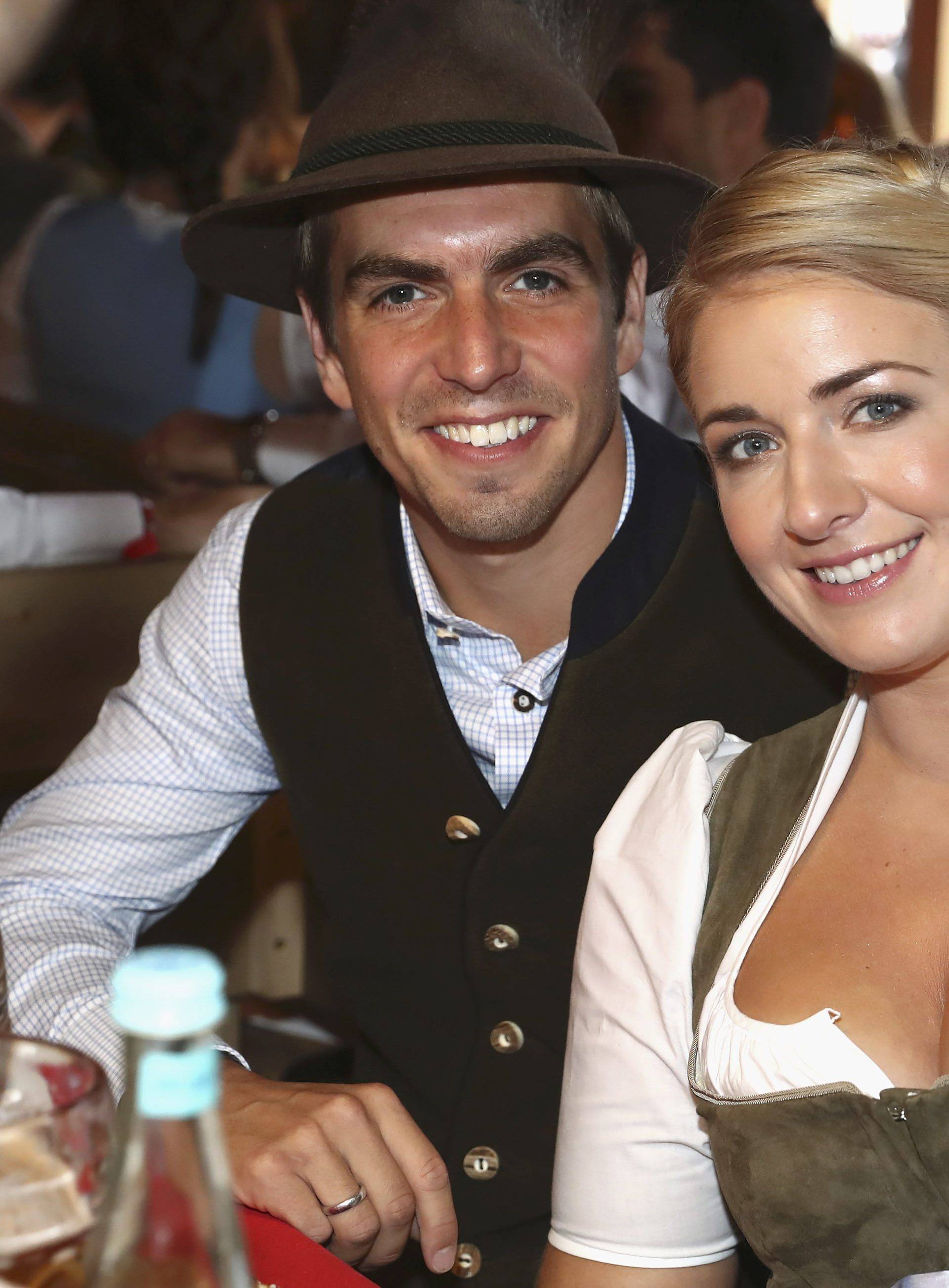 Lahm of FC Bayern Munich and his wife Claudia pose during their visit at the Oktoberfest in Munich