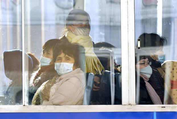 Passengers wear masks inside a trolley bus in Pyongyang