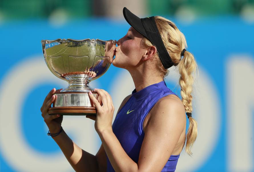 Croatia's Donna Vekic celebrates winning the final with the trophy