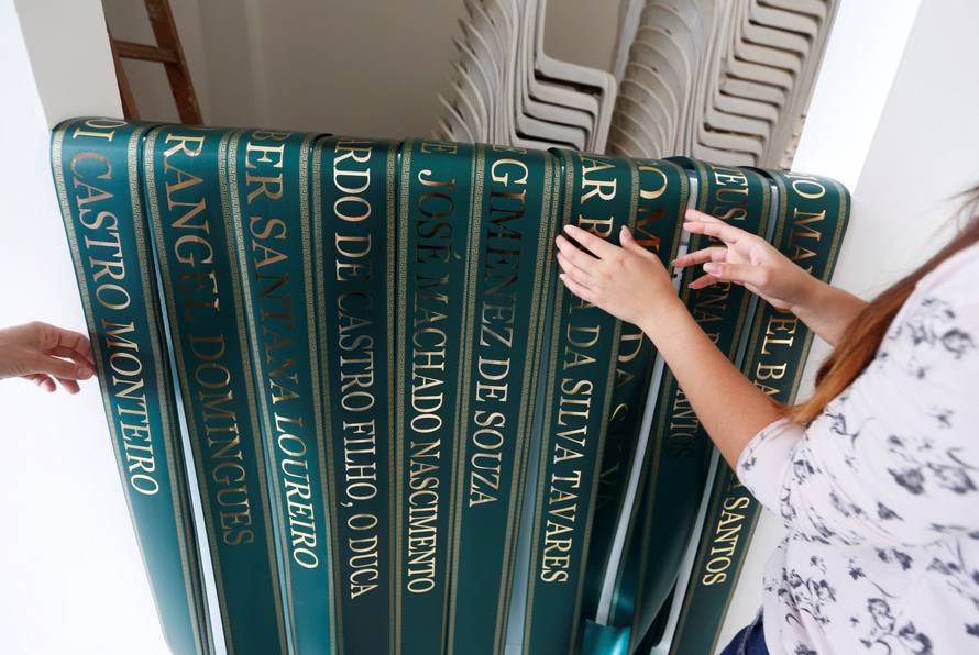 Funeral workers arrange ribbons with the names of the victims who died in an accident of the plane that crashed into the Colombian jungle with Brazilian soccer team Chapecoense onboard, in Medellin
