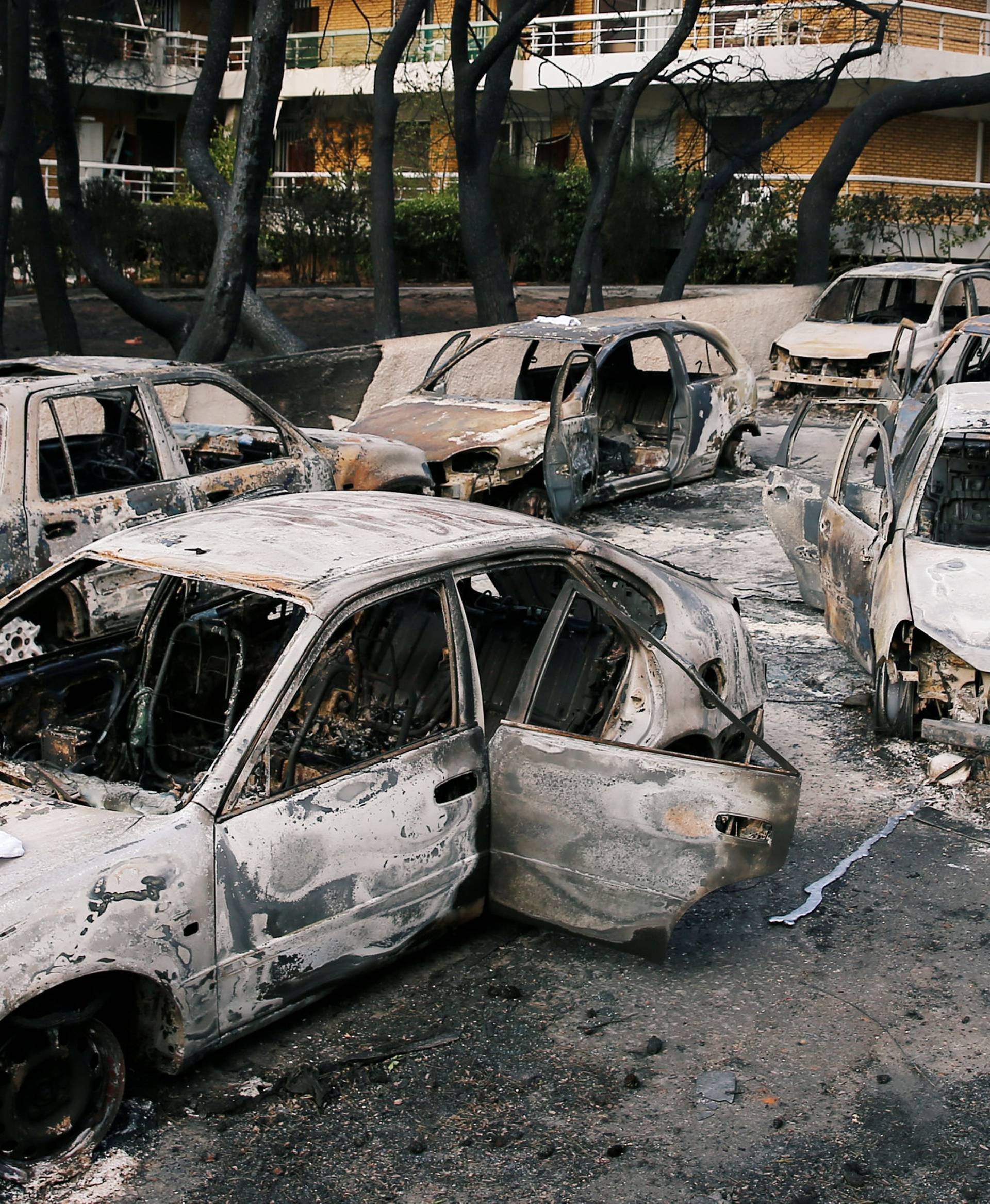 Burned cars are seen following a wildfire at the village of Mati, near Athens