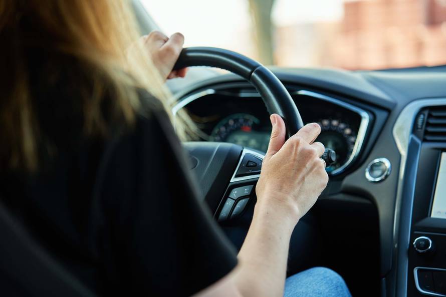 Close,Up,View,Of,Female,Driver,Hands,On,Steering,Wheel.