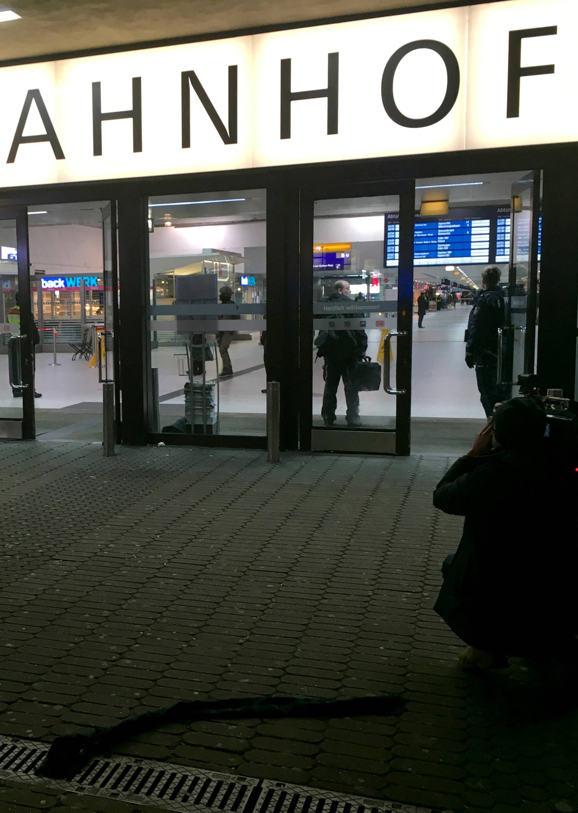 A cameraman films the entrance of the Duesseldorf main train station