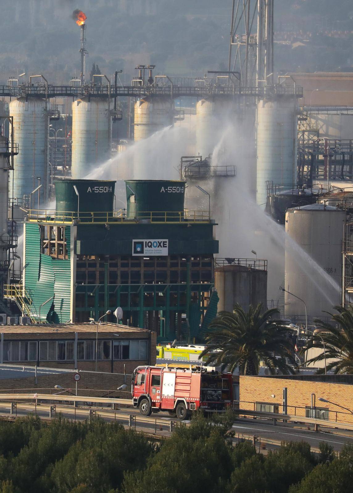 Firefighters spray water after a large fire broke out at the chemical factory, after explosion at a factory in the Tarragona