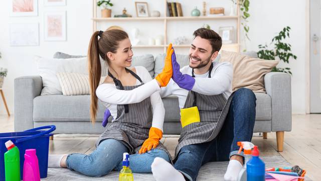 Fun,Cleaning,Together.,Smiling,Man,And,Woman,In,Aprons,And