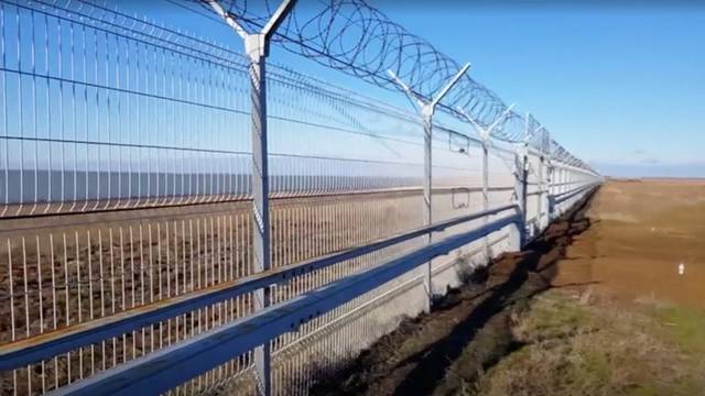 A still image taken from a video footage shows a 60-kilometre fence separating Crimea peninsula from continental Ukraine in Armyansk region