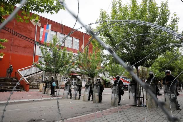 Polish members of the NATO-led Kosovo Force (KFOR) stand guard near a municipal office in Zvecan