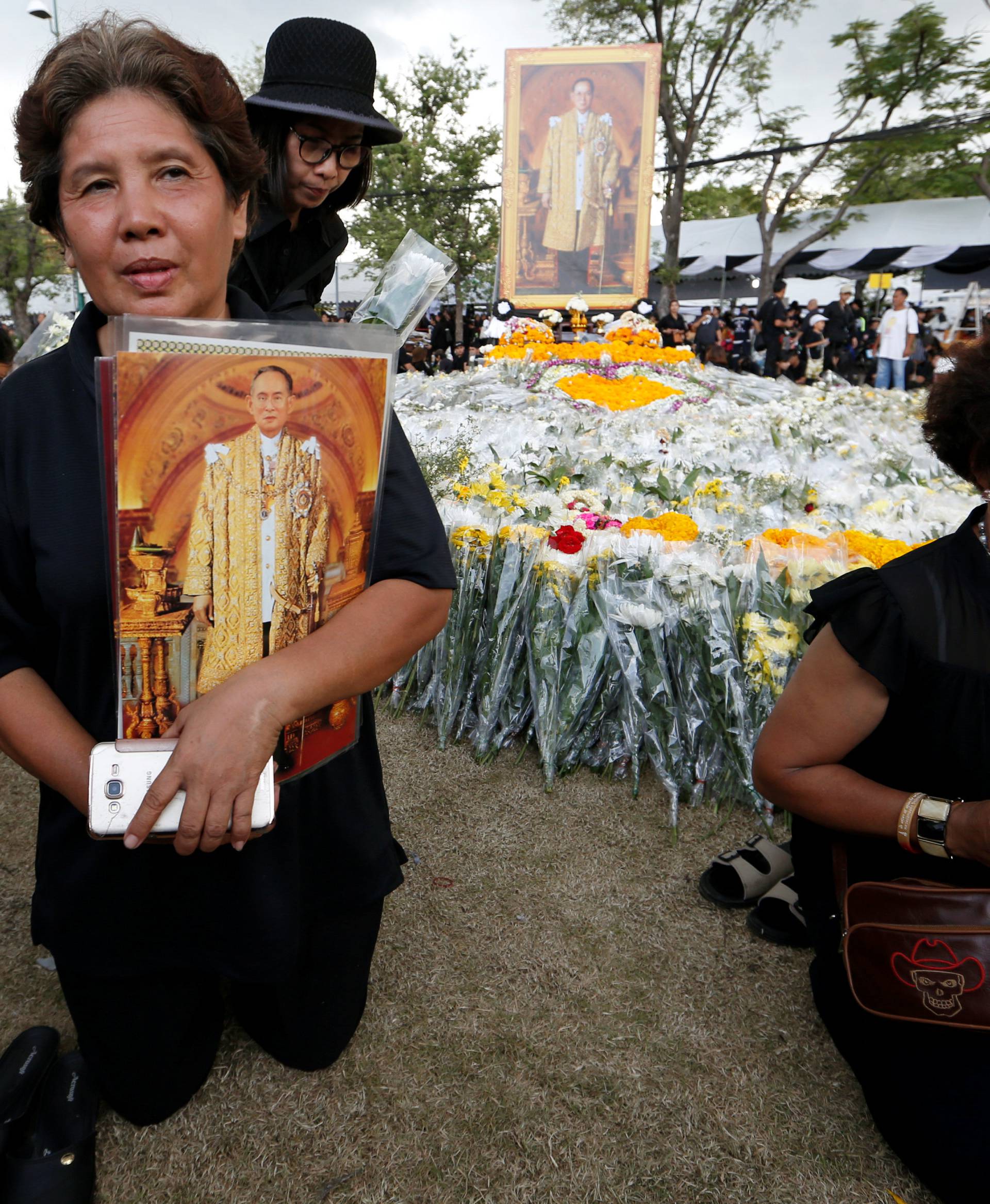 Mourners place flowers outside of the Grand Palace in honour of Thailand's late King Bhumibol Adulyadej in Bangkok