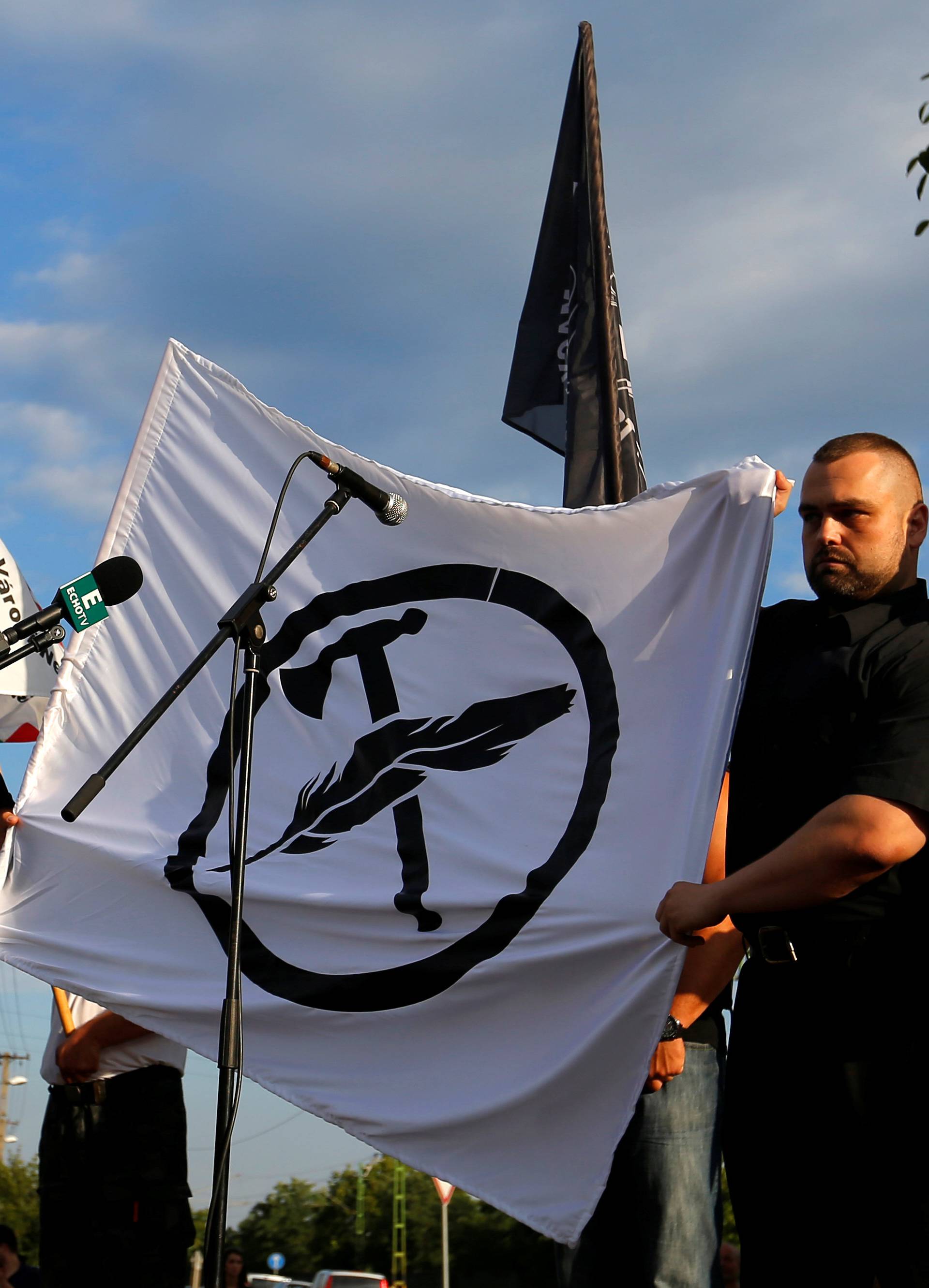 Leaders of a new Hungarian extreme right group unfurl the flag of their new movement, to be called Force and Determination, at a rally in Vecses