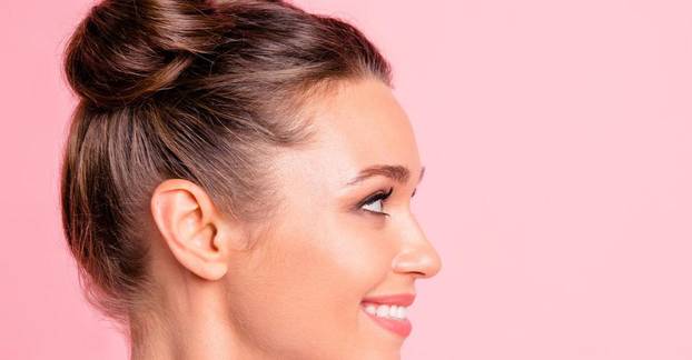 Close-up profile side view of nice lovely cute fascinating attractive groomed cheerful cheery girl looking aside copy empty blank space place isolated over pink pastel background