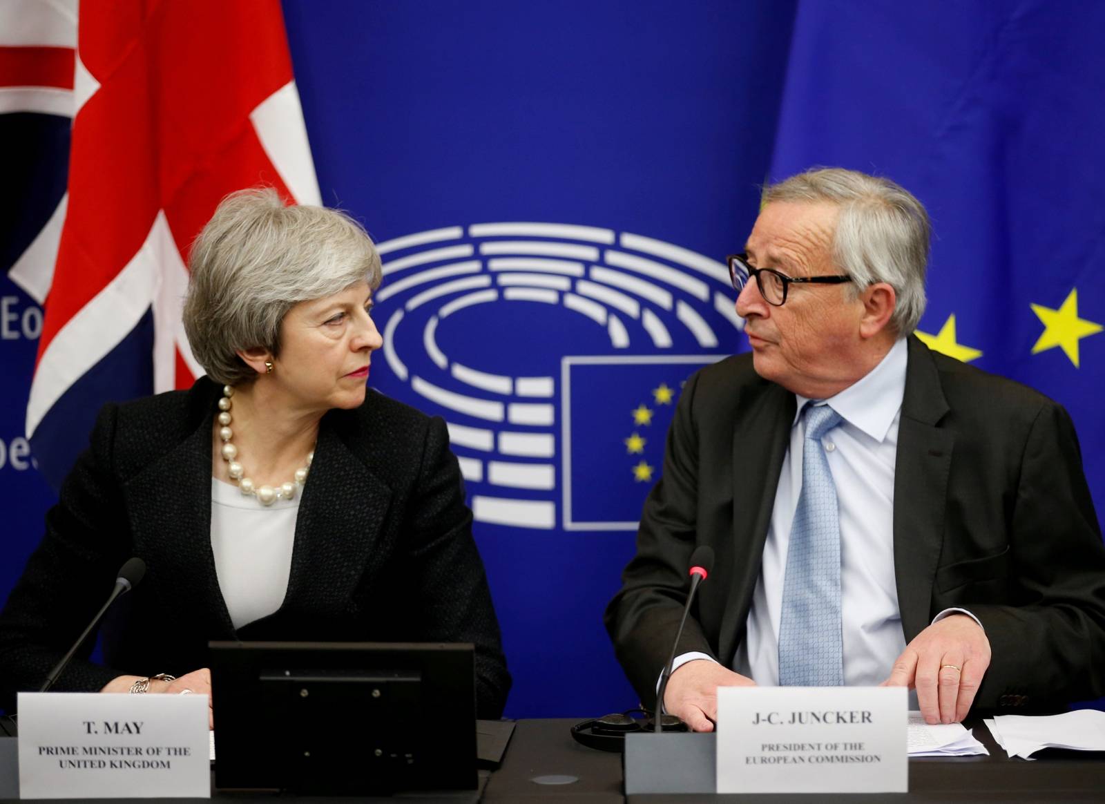 FILE PHOTO: British Prime Minister Theresa May and European Commission President Jean-Claude Juncker look at each other during a news conference in Strasbourg