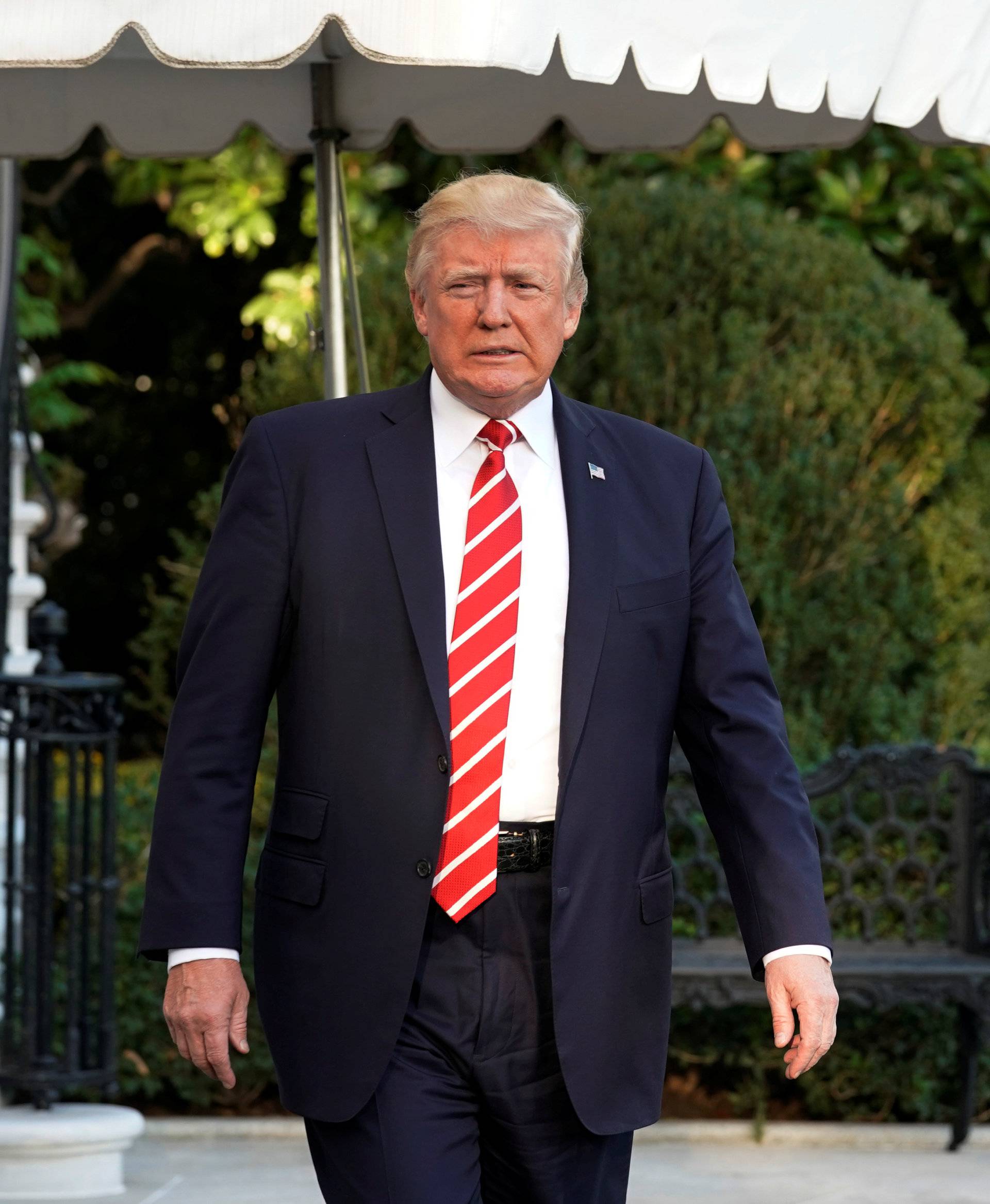 U.S. President Donald Trump walks out from the White House in Washington