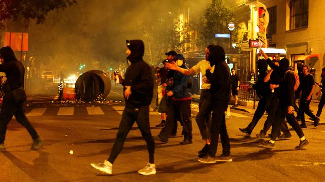 People protest against the French far-right Rassemblement National party, following partial results in the first round of the early 2024 legislative elections, in Paris