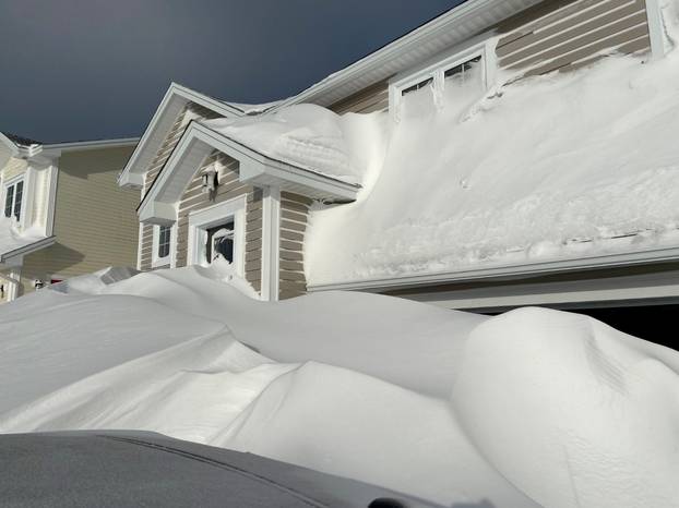 Pile of snow is pictured outside a house in St John