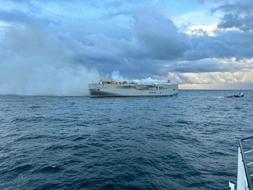 FILE PHOTO: Smoke rises as a fire broke out on the cargo ship Fremantle Highway, at sea