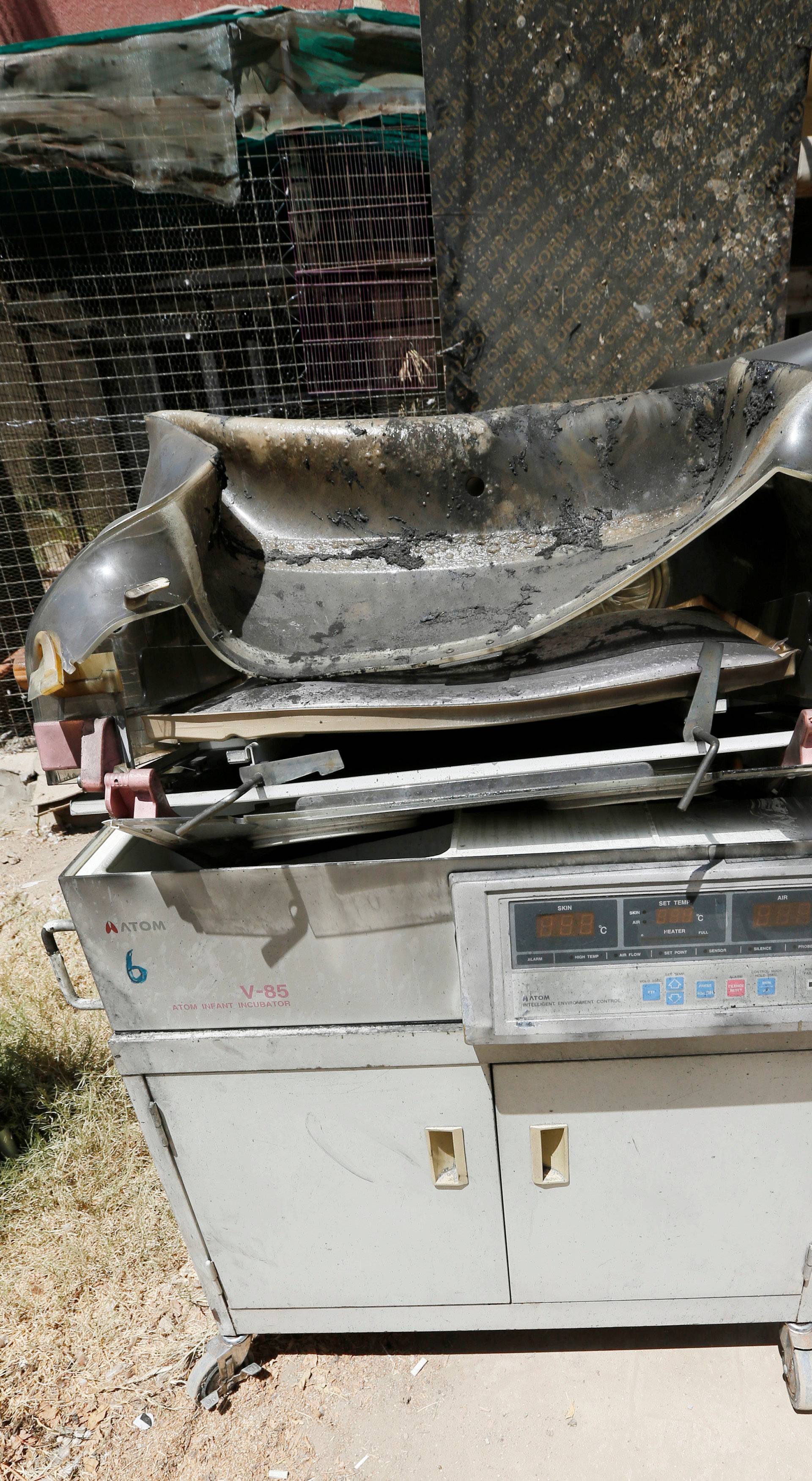 Burnt incubators stand outside a maternity ward after a fire broke out at Yarmouk hospital in Baghdad