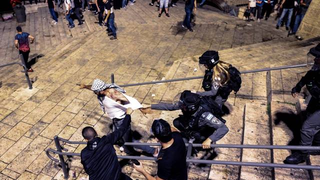 Israeli Border Police force detain a Palestinian protestor during clashes at Damascus Gate by the entrance to Jerusalem's Old City