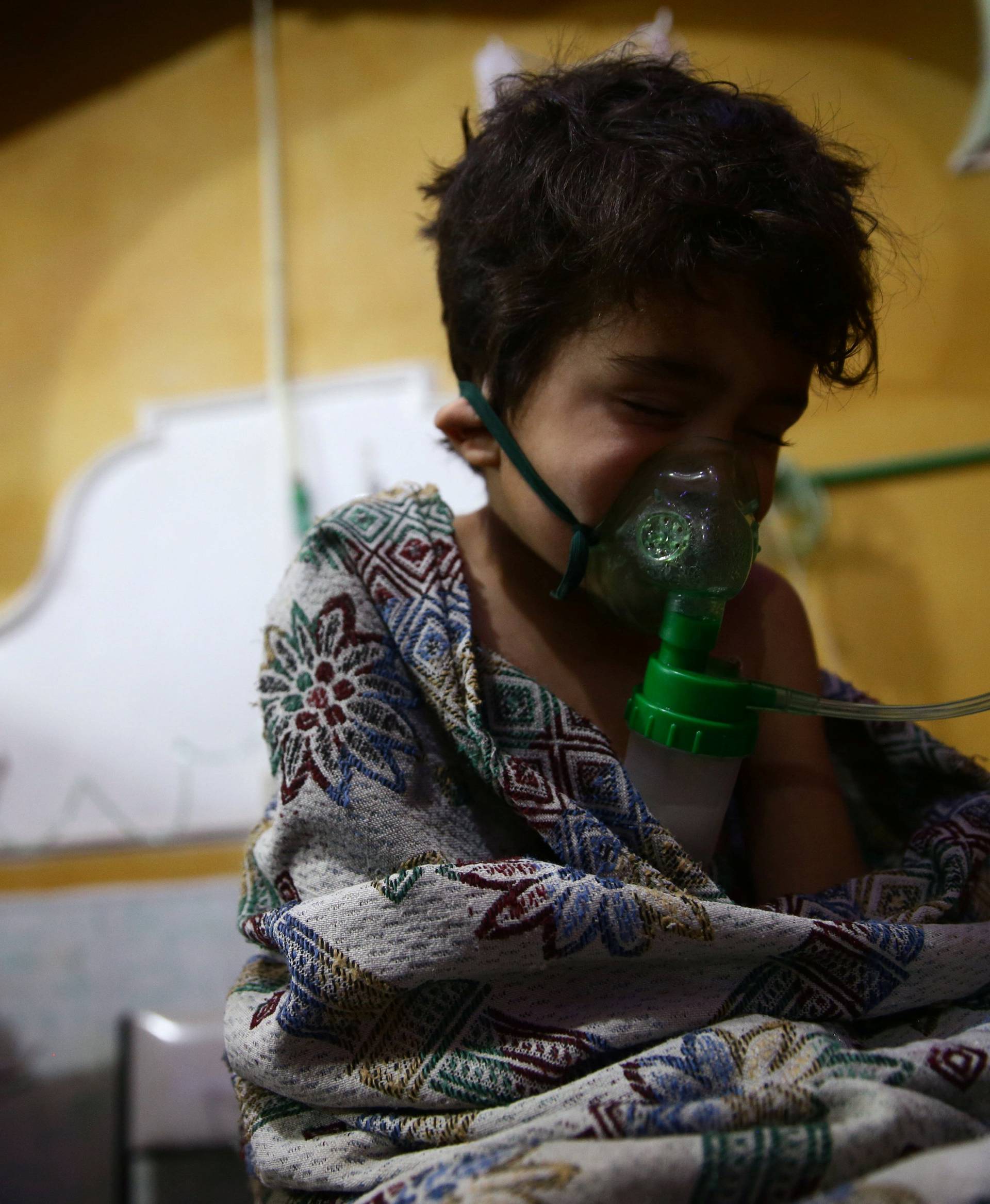 Child and man are seen in hospital in the besieged town of Douma, Eastern Ghouta, Damascus