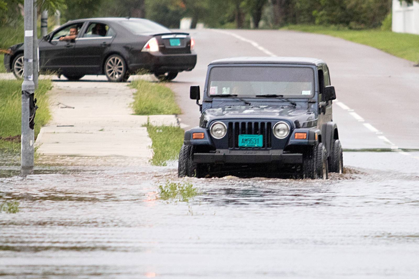 A Jeep drives through a flooded street after the effects of Hurricane Dorian arrived in Nassau