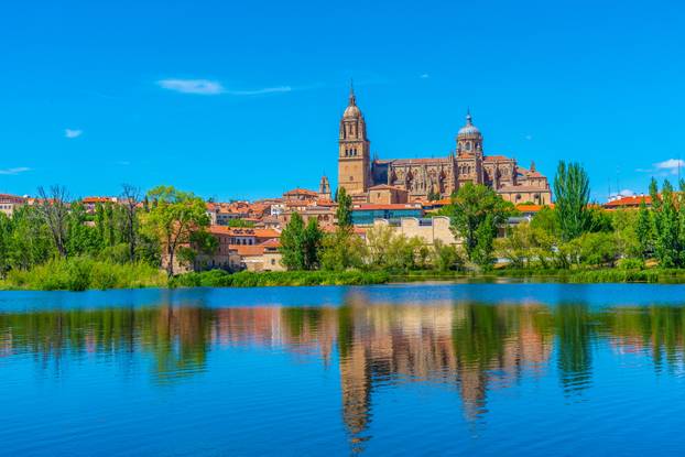 Cathedral at Salamanca reflected on river Tormes, Spain