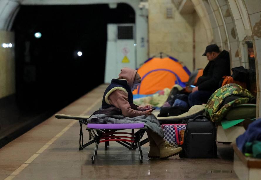 People take shelter inside a metro station during a Russian missile and drone attack in Kyiv