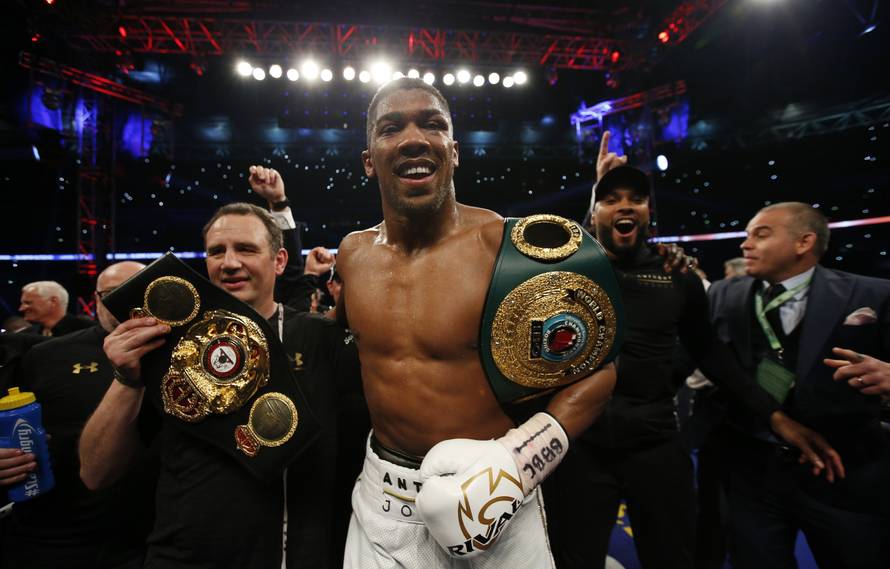 Anthony Joshua celebrates with trainer Robert McCracken after winning the fight