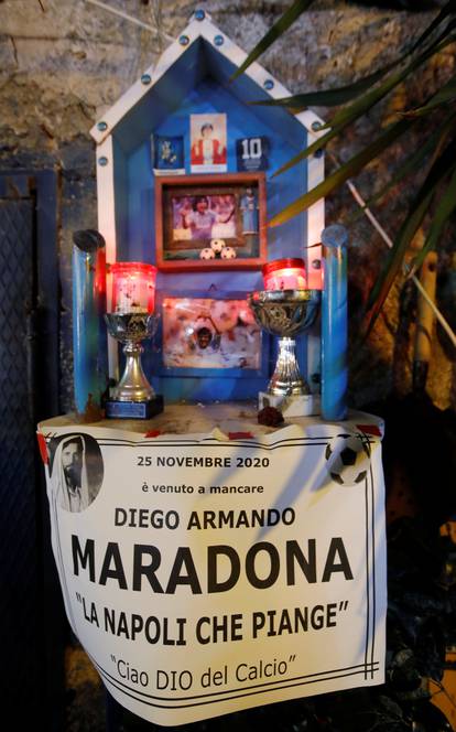 People gather to mourn the death of Argentine soccer legend Diego Maradona, in Naples