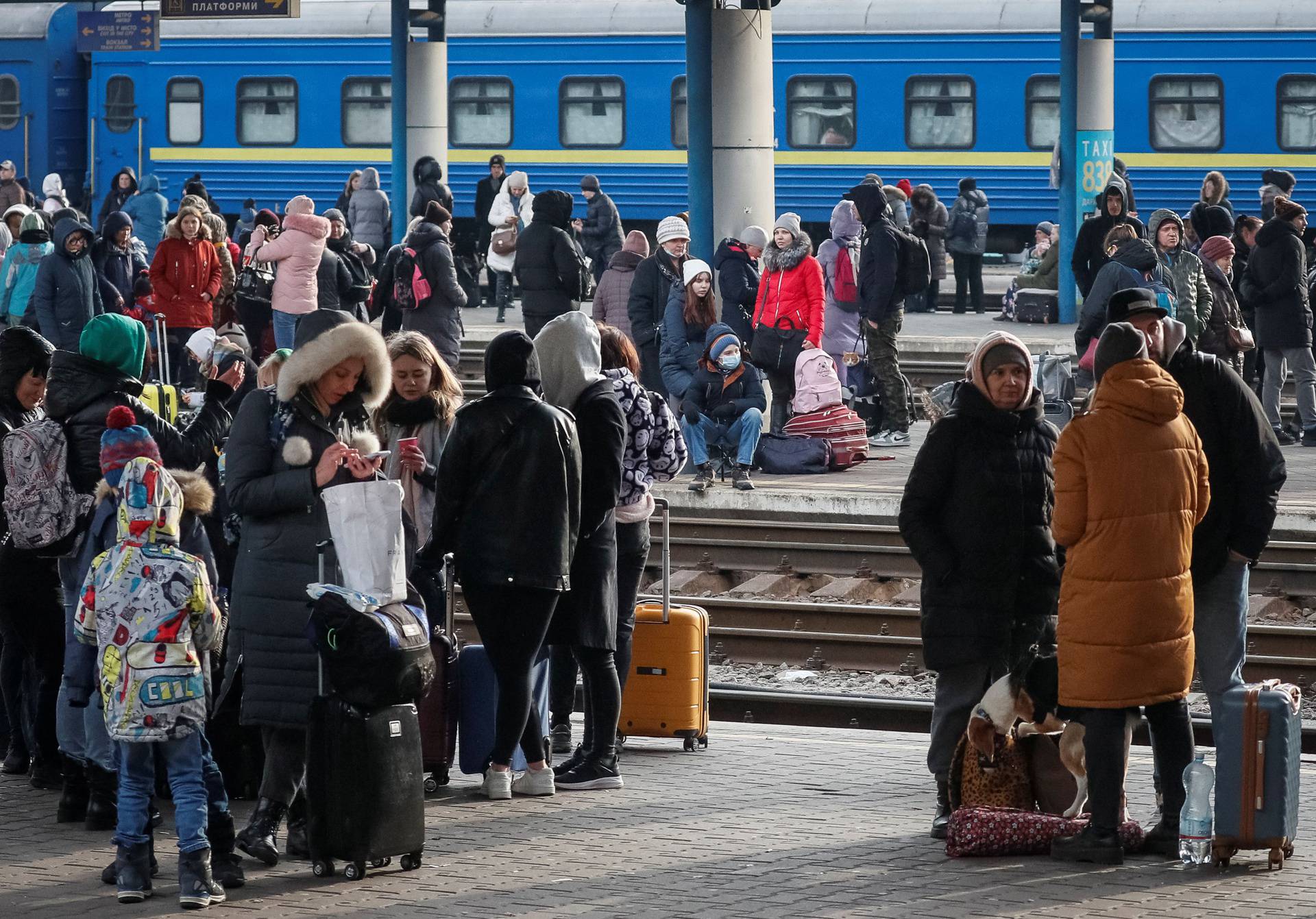 People wait to board an evacuation train at Kyiv central train station
