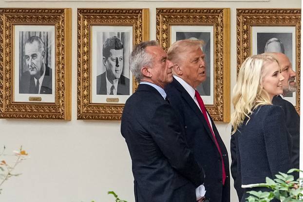U.S. President Trump shows photographs of former U.S. presidents in the Colonnade at the White House in Washington