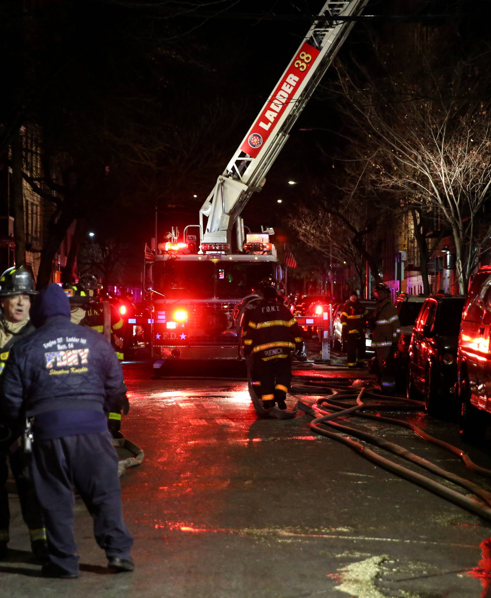 Fire Department of New York (FDNY) personnel work on the scene of an apartment fire in New York