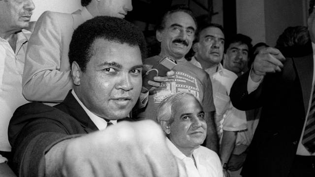 File photo of Muhammad Ali showing his fist to reporters during an impromptu news conference in Mexico City