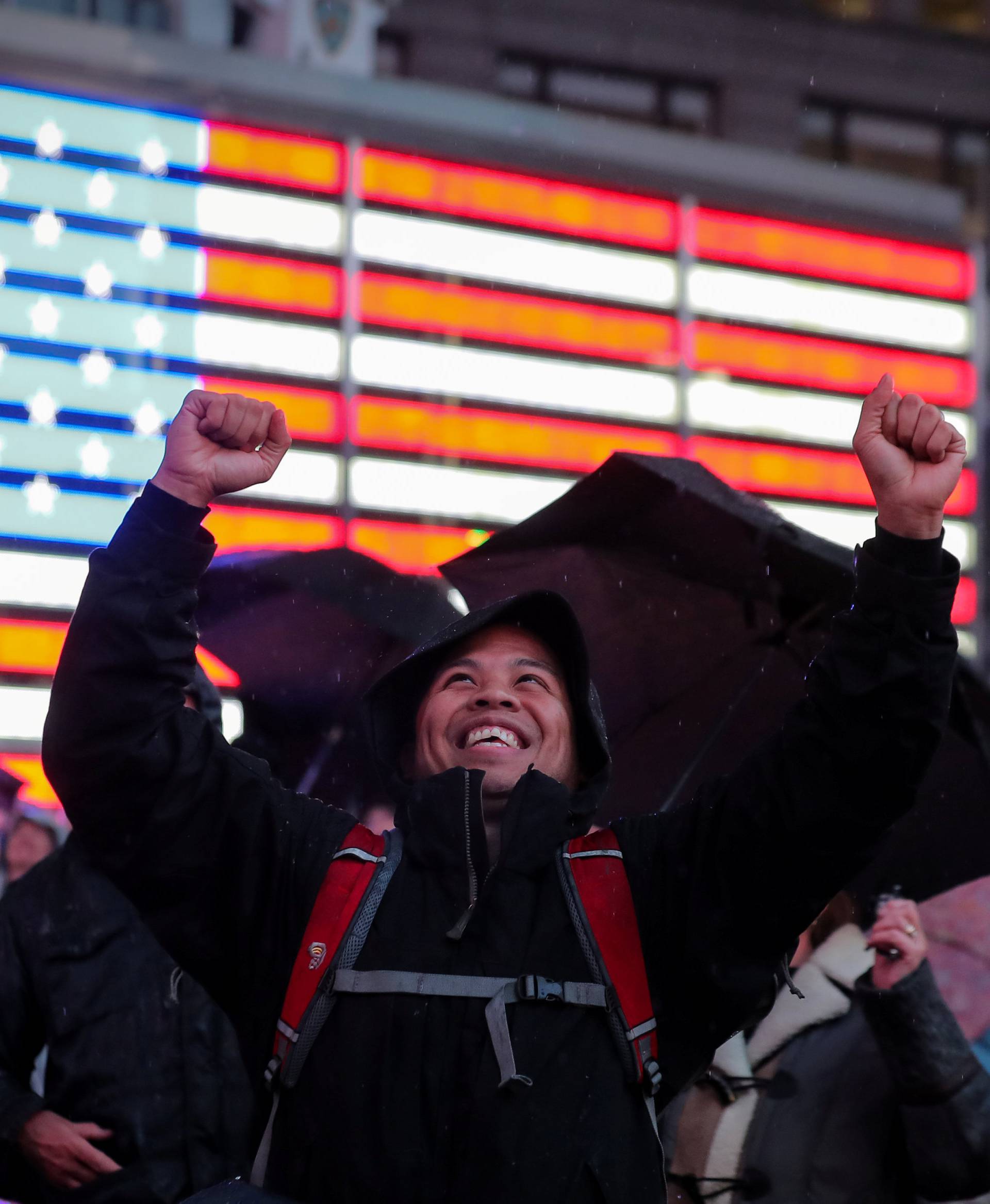 People react as they watch on a video screen as the spaceship InSight lands on Mars surface after a six-month journey, in Times Square in New York