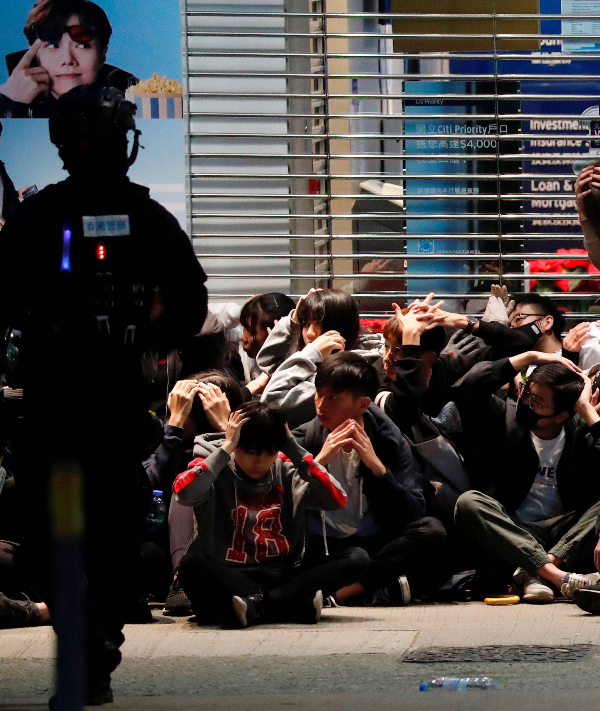 Riot police detain anti-government protesters in a large scale during a legal demonstration on the New Year's Day to call for better governance and democratic reforms in Hong Kong