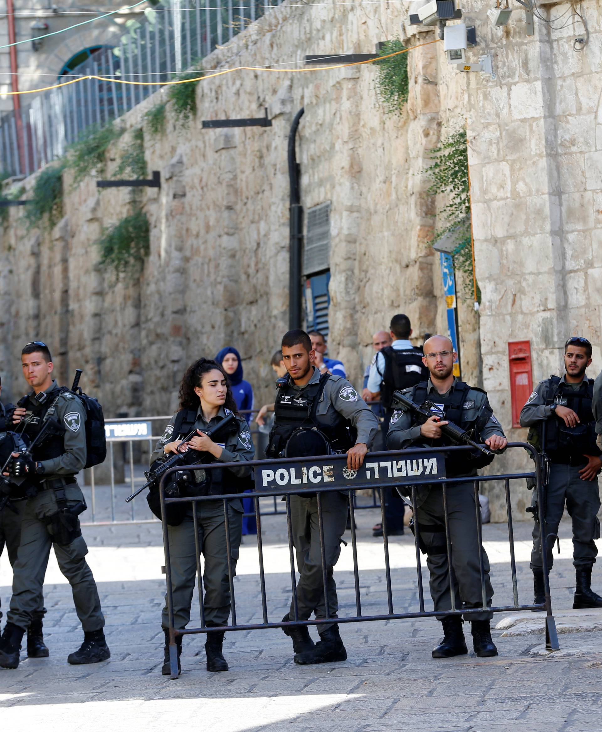 Israeli border policemen secure the area near the scene of the shooting attack, in Jerusalem's Old City