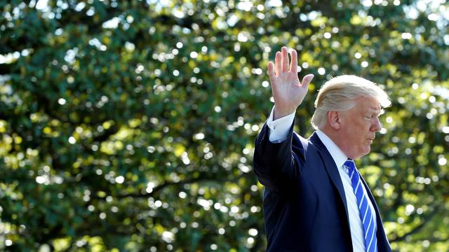 FILE PHOTO: U.S. President Donald Trump waves as he walks on the South Lawn of the White House in Washington