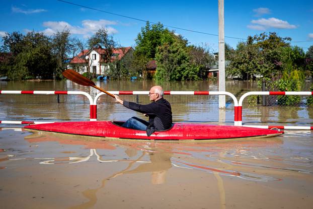 Man paddles in a kayak amid flooding in Czechowice-Dziedzice, Silesia