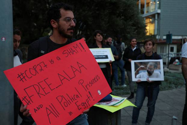 Demonstrators hold signs as they demand the release of Egyptian-British hunger striker Alaa Abd el-Fattah near the British Embassy in Beirut