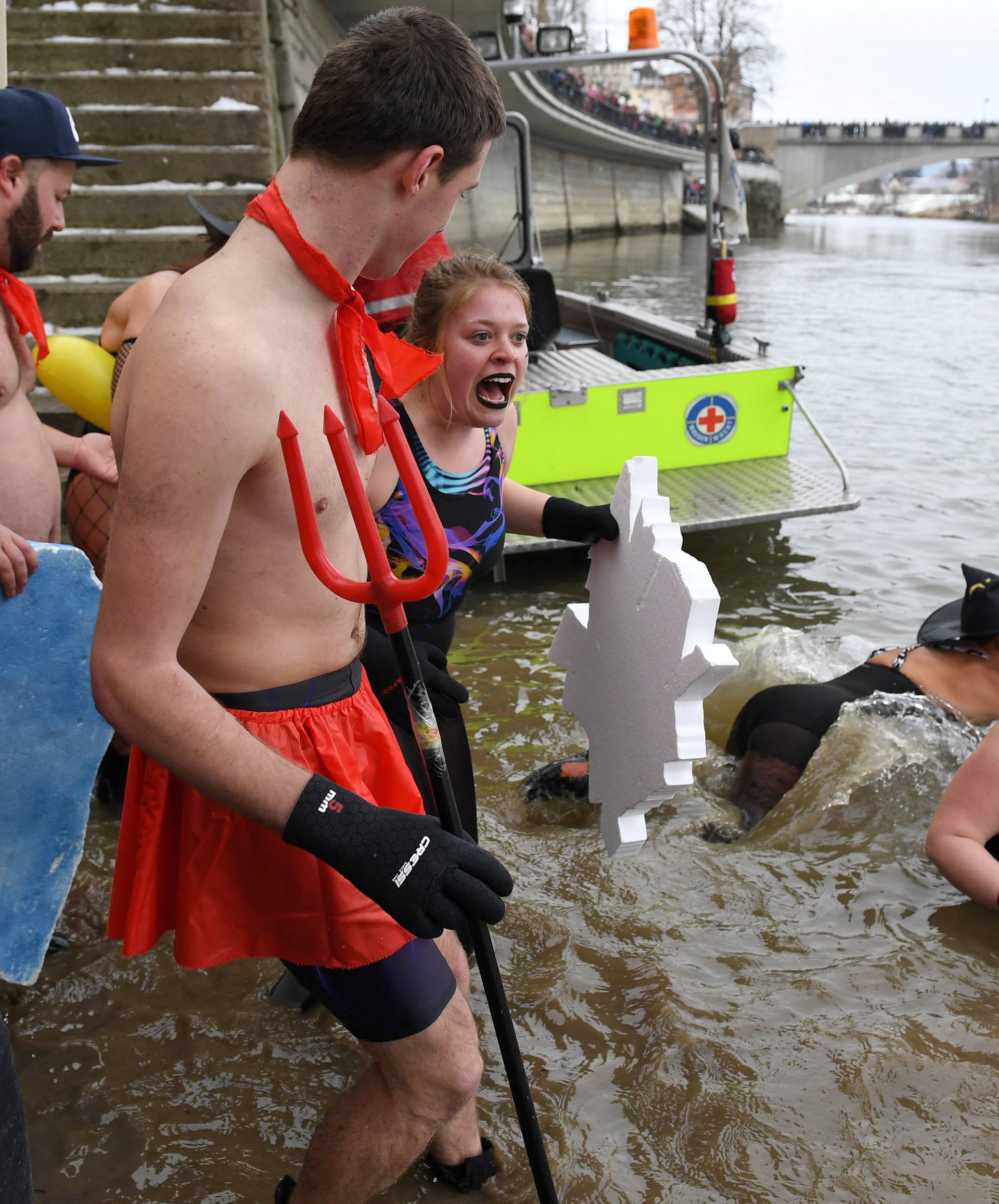 Swimmers wearing costumes bathe in the 3 degrees Celsius water of the river Danube in Neuburg an der Donau
