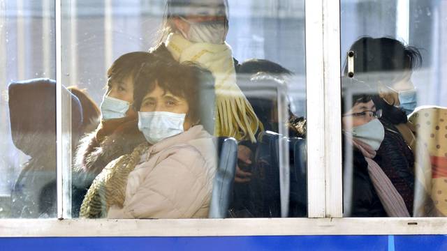 Passengers wear masks inside a trolley bus in Pyongyang