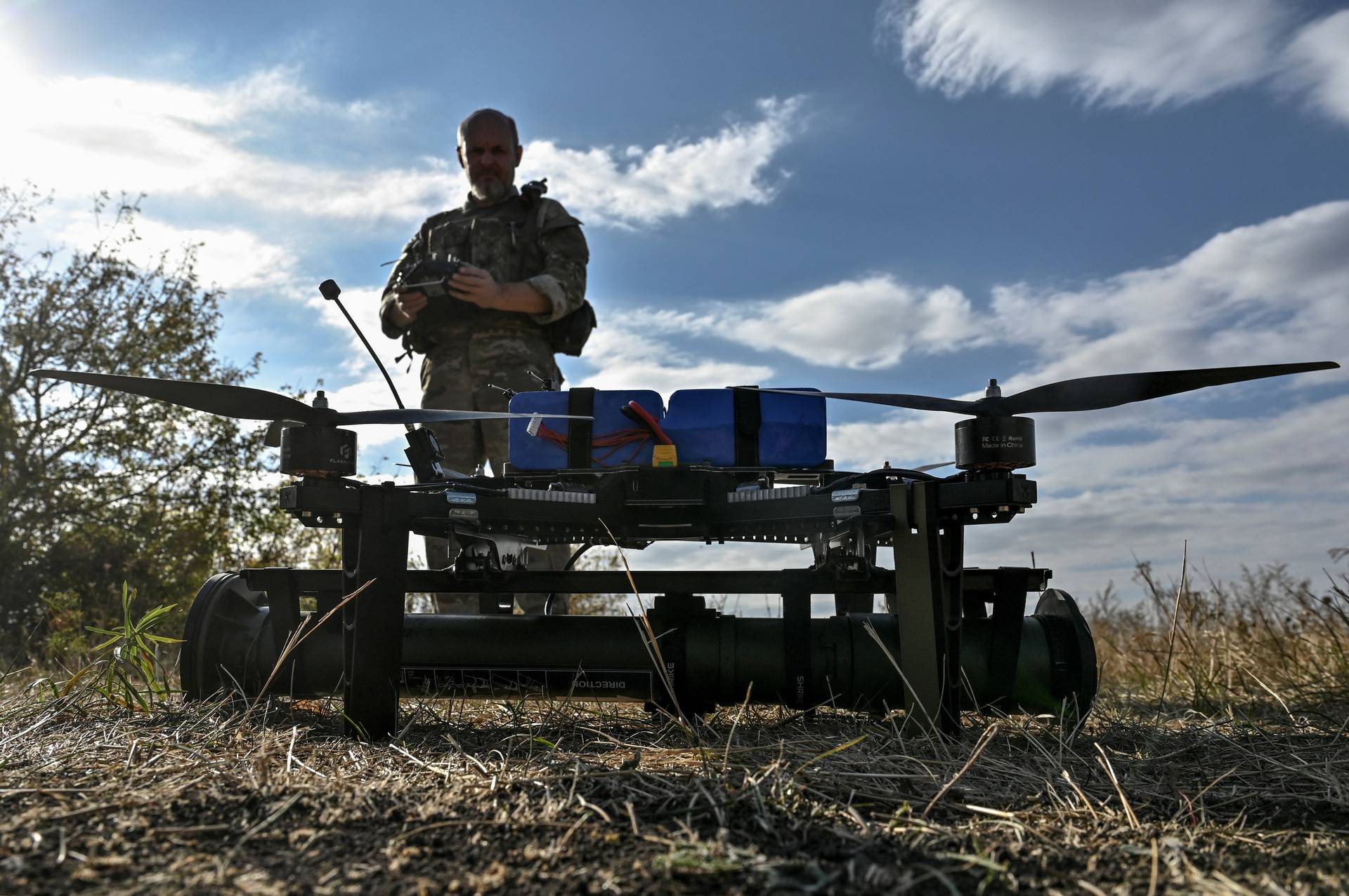 Ukrainian serviceman prepares to fly an FPV drone with an attached portable grenade launcher at their position near a frontline in the Zaporizhzhia region