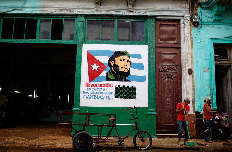 A painting depicting Cuba's late president Fidel Castro decorates a wall outside a subsidised state store in Havana