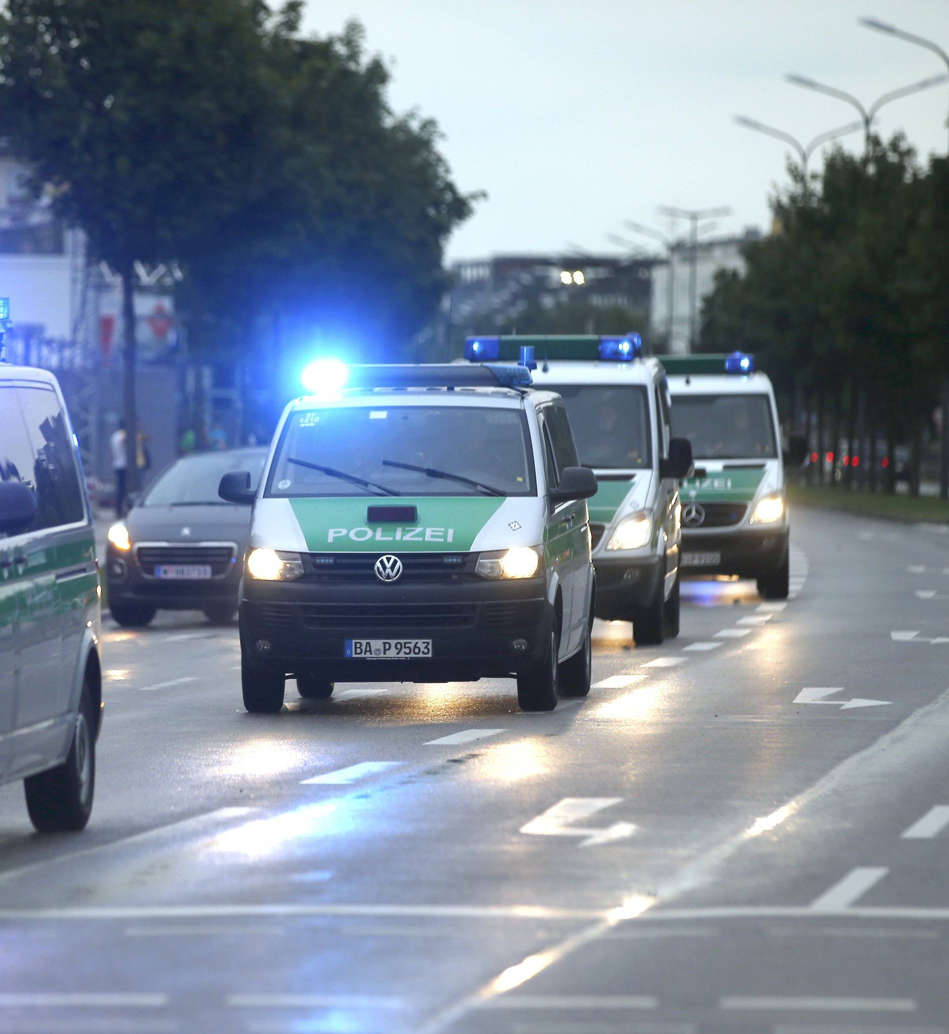 Police make their way to the scene of a shooting rampage at Olympia shopping mall in Munich