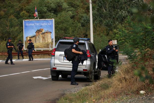 Kosovo police and U.S. and EU troops stand by after one police officer was killed, another hurt in Kosovo gunfire, in Josevik