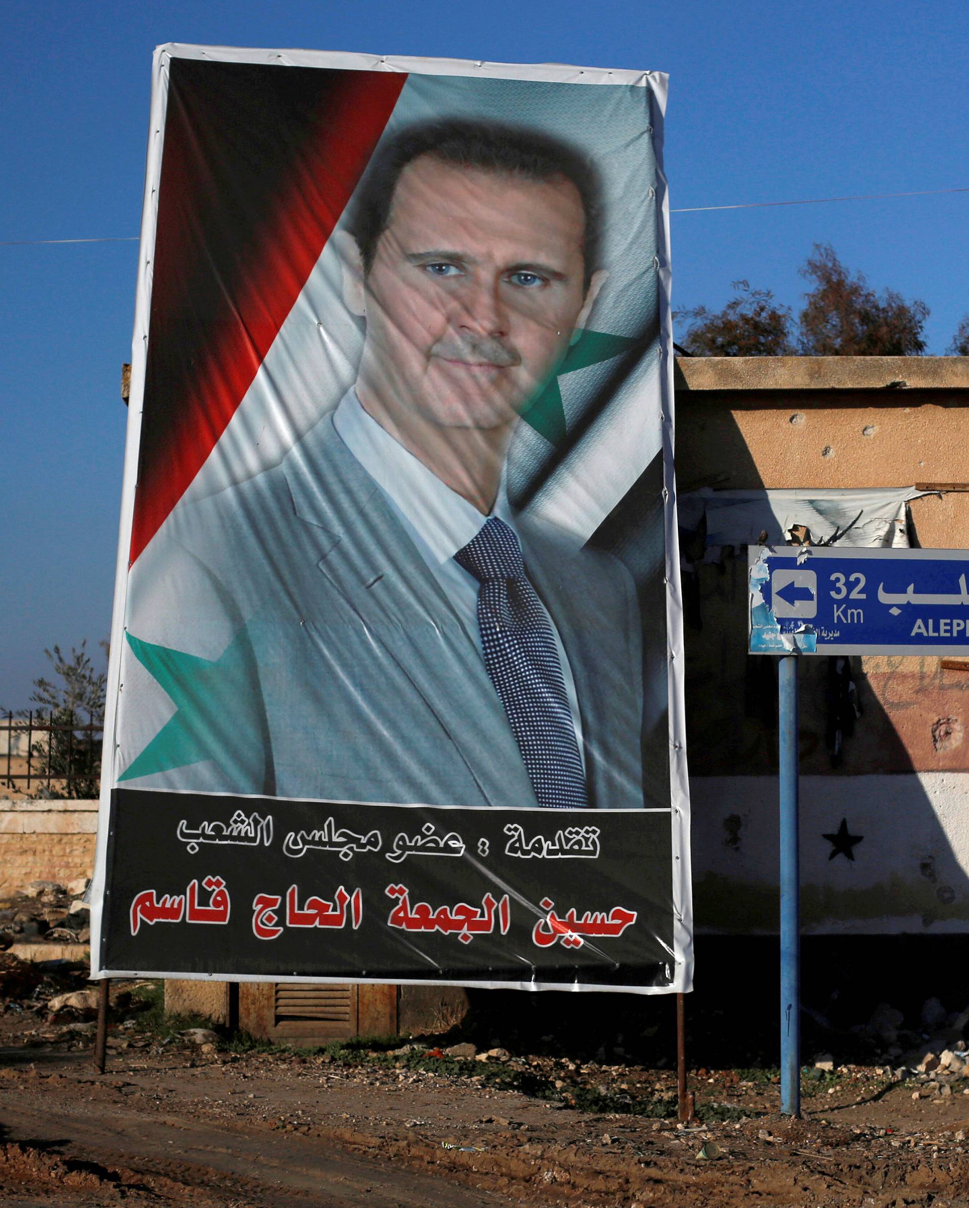 File photo shows a picture of Syria's President Bashar al-Assad in Ramouseh, a government controlled area of Aleppo, Syria