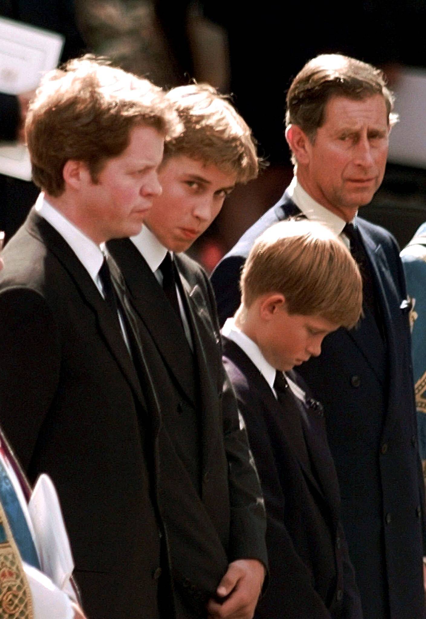 FILE PHOTO: (R-L) Prince Charles, Prince Harry, Prince William and Earl Spencer watch as the coffin containing t..